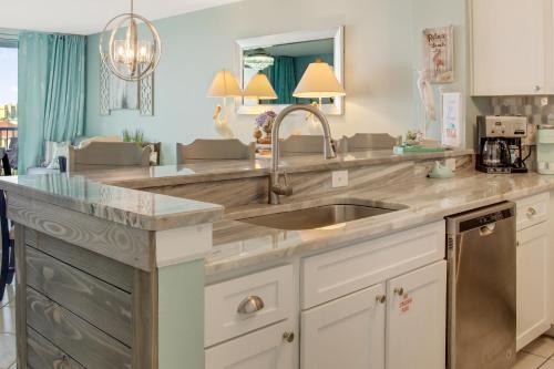 a kitchen with a sink and a counter at Pelican Beach Paradise! in Destin