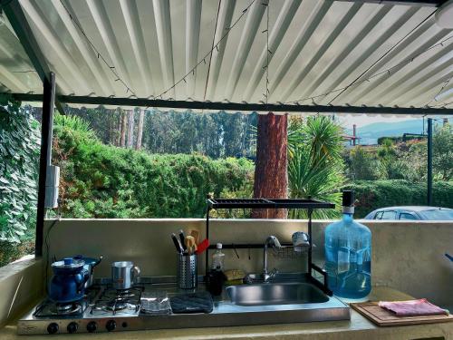 a kitchen counter with a sink and a window at TINY EL ZAPATO in Suesca