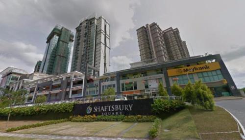 a building with a sign in front of some tall buildings at 10am-6pm, SAME DAY CHECK IN AND CHECK OUT, Work From Home, Shaftsbury-Cyberjaya, Comfy Home by Flexihome-MY in Cyberjaya