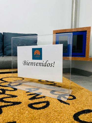 a sign for the bernethuds on a rug on a living room at Casa De Campo Mirador H&L in San Antonio de las Alzanas