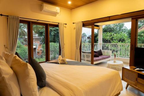 a bedroom with a bed with a teddy bear on it at Villa Baru 3 Bedroom in Tabanan