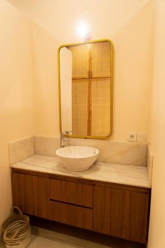 a bathroom with a sink and a mirror at Villa Baru 3 Bedroom in Tabanan