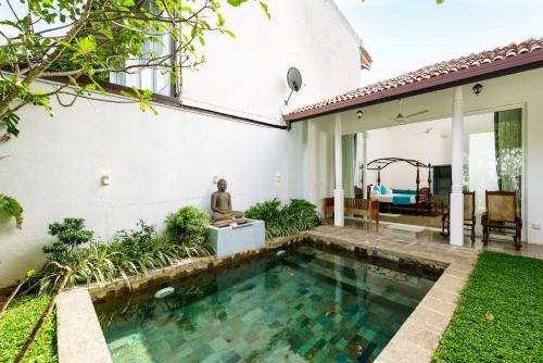 a swimming pool in the backyard of a house at Angam Villas Colombo in Colombo