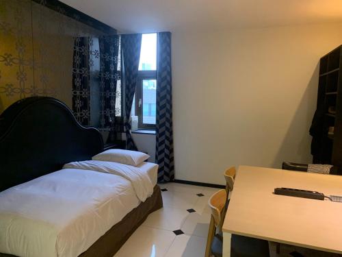 a bedroom with a bed and a table and a window at Hotel Doma Myeongdong in Seoul