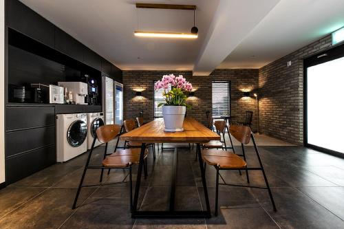 a dining room with a table and chairs with flowers on it at Hotel Yaja Masan Odong Branch in Changwon