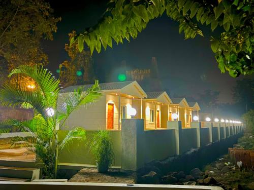 a row of houses at night with lights at Tara's Hill Resort in Lonavala