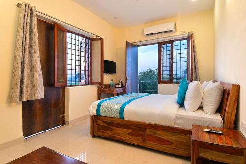 a bedroom with a bed and a large window at Hotel The York in Noida