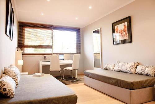 カンヌにある90m2 Apartement - Les Palmiers de Cannesのベッド2台とデスクが備わる客室です。