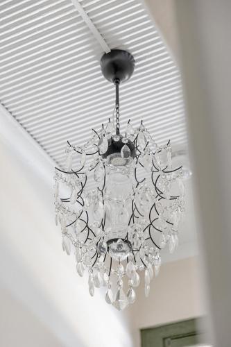 a chandelier hanging from a ceiling in a room at Discover The Rocks - Historical Terrace House in Sydney