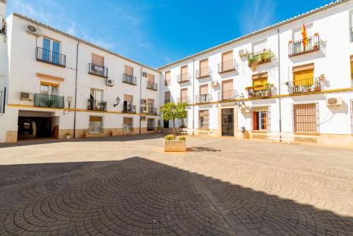 a courtyard of a large white building at Apartamento Andalucía Centro III in Antequera