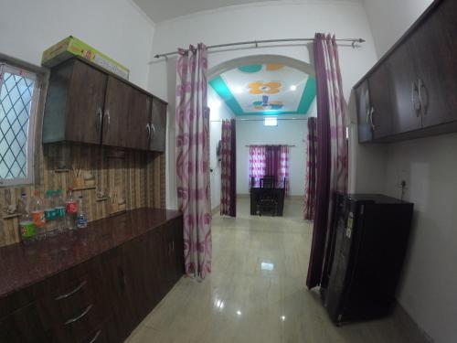 an empty room with a kitchen and a hallway at Gaharwar Home Stay in Dehradun