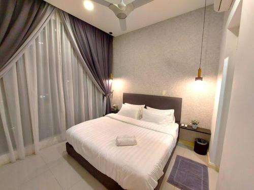 a bedroom with a large bed with a large window at Walk to Legoland * D'Pristine * 2BR Pool View #7 in Nusajaya