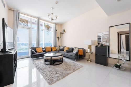 a living room with a couch and a table at Great Gatsby's Home in Dubai