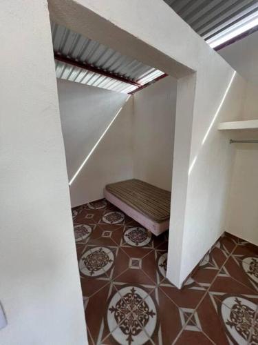 a room with a staircase with a bench on the floor at Departamento Carnaval in Autlán de Navarro