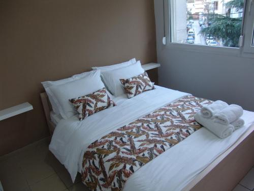 a bed with towels and pillows on it in a room at Kapsouli square 2 in Komotini