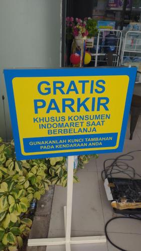 a sign in front of a store with a sign at Padina Soho And Residence in Kebonbesar