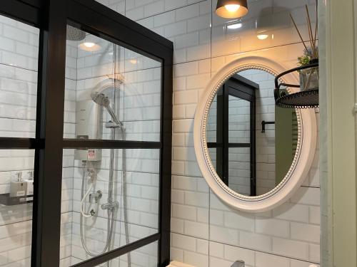 a bathroom with a shower and a mirror at Jessie Home in Bukit Mertajam