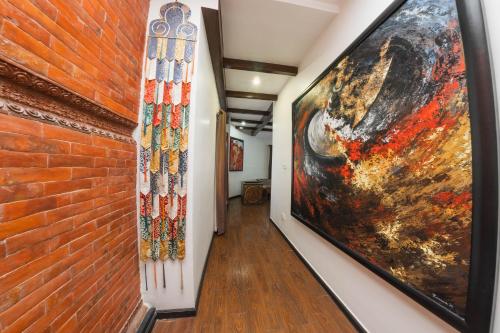 a hallway with a large painting on the wall at Dalai-La Boutique Hotel in Kathmandu