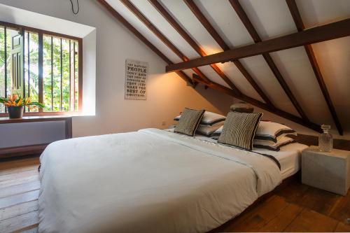 a bedroom with a large bed in a attic at MO River House Luxury Villa in Hikkaduwa