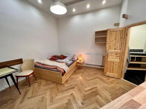 a bedroom with a bed and a table and a desk at Cozy designer apartment in Friedrichshain in Berlin
