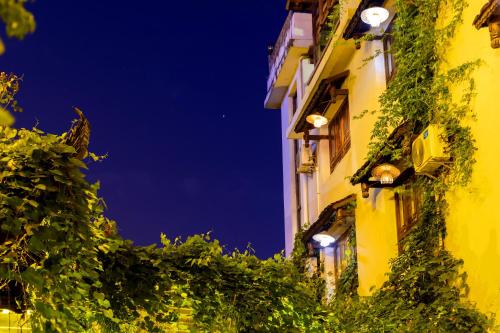 a building with lights on the side of it at night at Butterfly Flowers Inn in Zhangjiajie