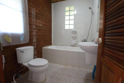 a bathroom with a toilet and a tub and a sink at Phuchomjan Resort in Mae Hong Son