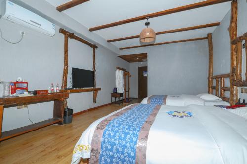 a bedroom with a bed and a television in it at Zhangjiajie Mountainside in Zhangjiajie