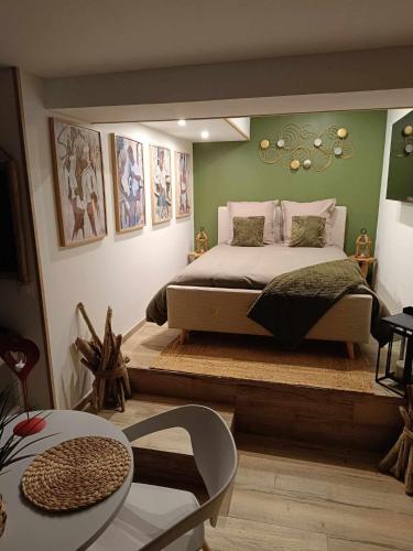 a bedroom with a bed and a large mirror at Ô Plaisir Ô Désir in Étaples