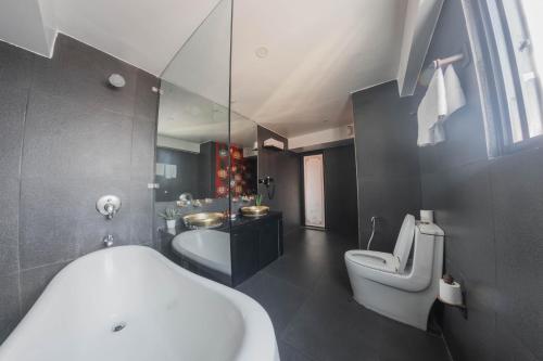 a bathroom with a tub and a toilet and a sink at Dalai-La Boutique Hotel in Kathmandu