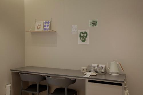 a desk in a room with two chairs in a room at Stay Dooroo in Suncheon