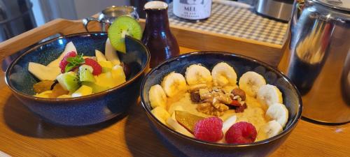 two bowls of fruit on a wooden table at House of Moitelas in Moitelas