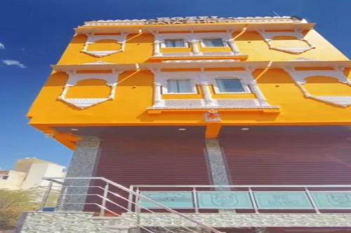 a tall yellow building with a yellow roof at OYO Hotel Data Shree in Udaipur