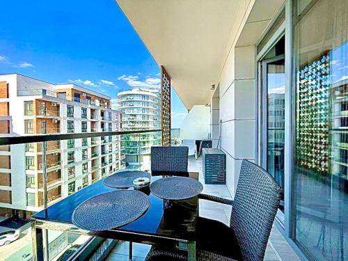 a balcony with a table and chairs on a balcony at Summerland Seaview Apartments in Mamaia