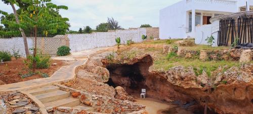 a house on top of a mountain with a tunnel at Cave Diani Holiday Apartments in Diani Beach