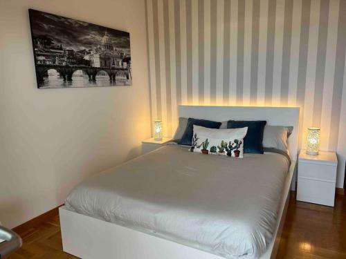 a bedroom with a large bed with two lamps at Appartamento raffinato su Roma zona Aurelia in Rome