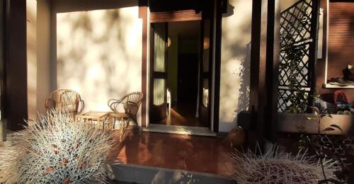 a front door of a house with chairs on the porch at Villa Paradis B&B in Airuno