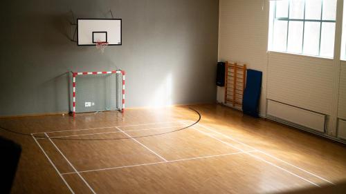an empty gym with a basketball hoop in a room at Medlefors Hotell & Konferens in Skellefteå