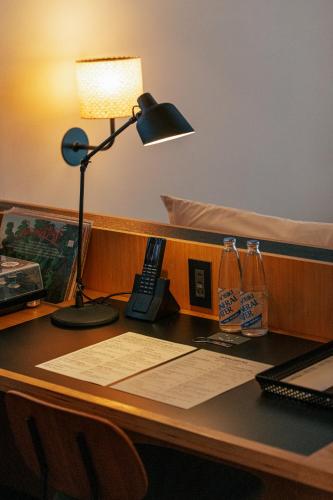 a desk with a lamp and a phone on it at Ace Hotel Kyoto in Kyoto