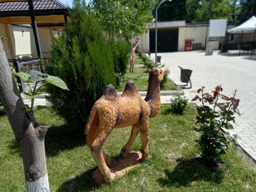 a statue of two camels standing in the grass at Gold Hotel Quba in Quba