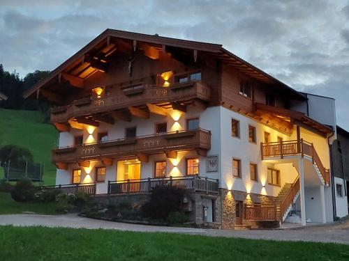 a large wooden house with lights on it at Erbhof Fritzing in Ebbs