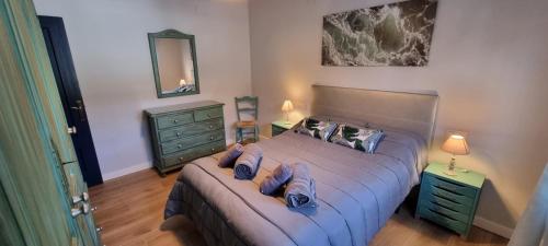a bedroom with a bed and two night stands and a mirror at Rincón de Elena in Quéntar
