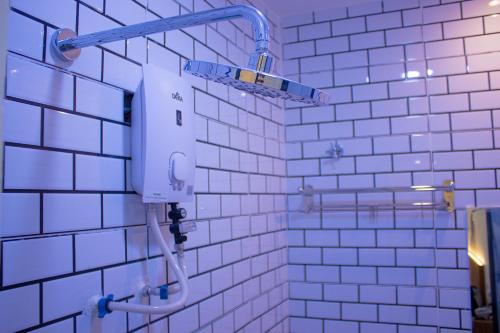 a bathroom with white tiled walls and a shower at Astar Hotel Kuala Lumpur in Kuala Lumpur