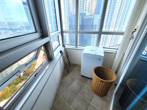 a room with windows and a trash can in a building at W Residence Hotel in Busan