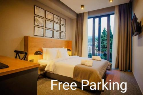 a hotel room with a bed with a free parking sign at Hotel Tuta in Tbilisi City