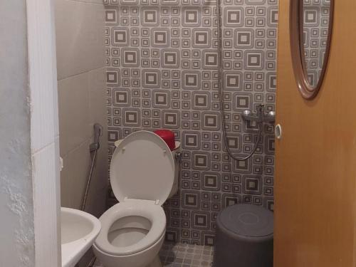 a bathroom with a toilet and a shower at RedDoorz near Pantai Pandan Sibolga 2 in Halangan