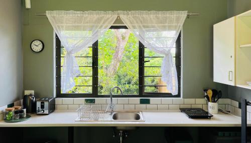 a kitchen with a sink and a window at Robyns Nest 2 Studio Cottage in Kloof