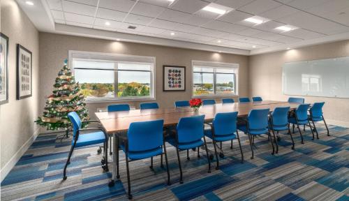 a conference room with a christmas tree and a long table and chairs at Holiday Inn Express & Suites - Brandon by IHG in Brandon
