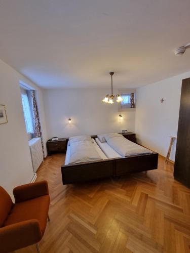 a large bedroom with a bed and a couch at Hotel St. Josefshaus Engelberg in Engelberg
