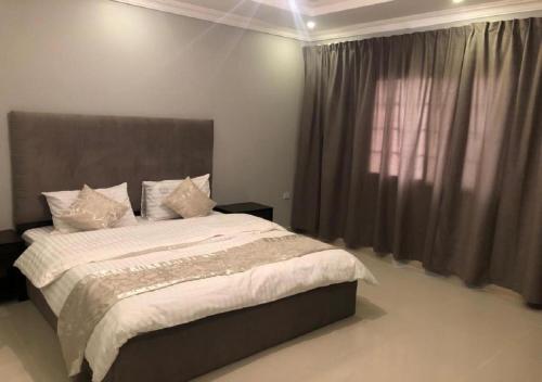 a bedroom with a large bed and a window at SNOW CLOUD in Abha