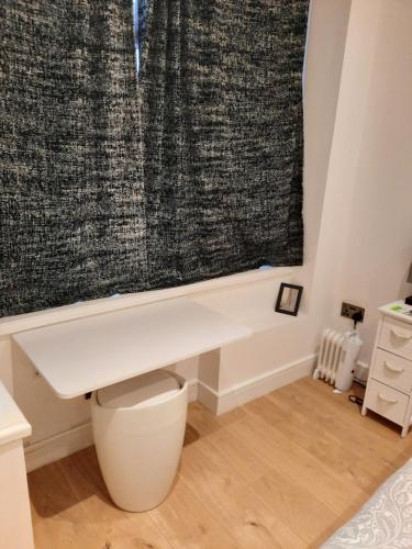 a bathroom with a white toilet and a shower curtain at Lovely Home with full en-suite double bed rooms in Reading